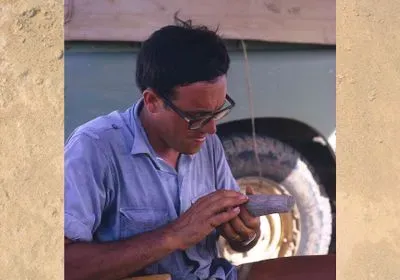 A young Maurice Taieb looks at a fossil.